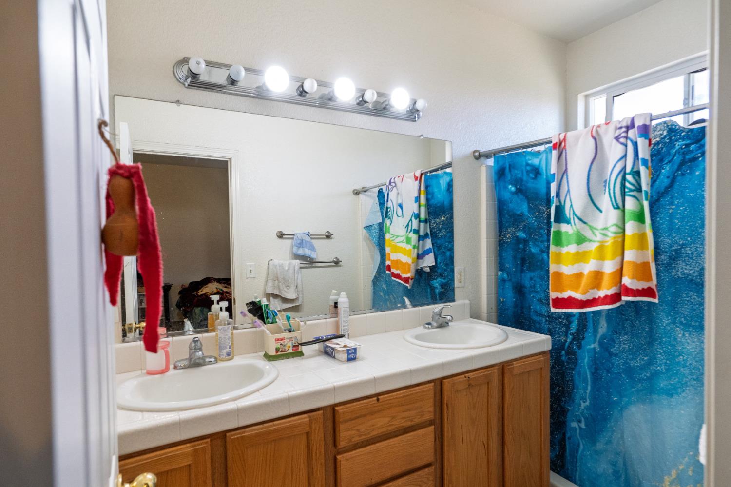 123 Manzanita Avenue Merced, CA 95341 - Photo 23 of 30 a bathroom with a sink vanity and a mirror
