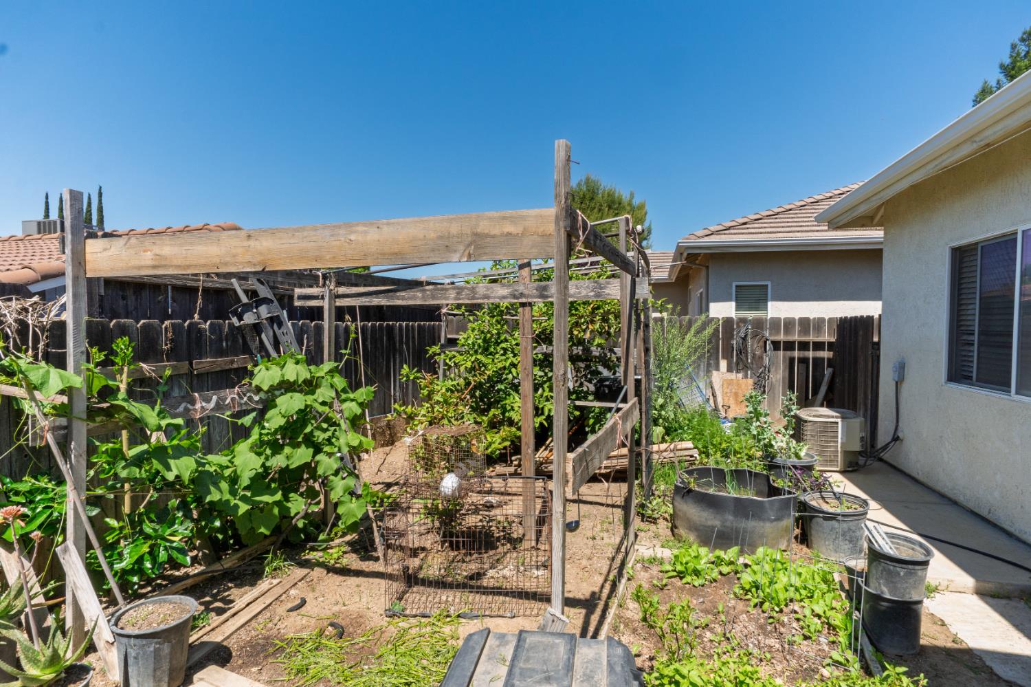 123 Manzanita Avenue Merced, CA 95341 - Photo 24 of 30 a view of a patio with table and chairs and potted plants