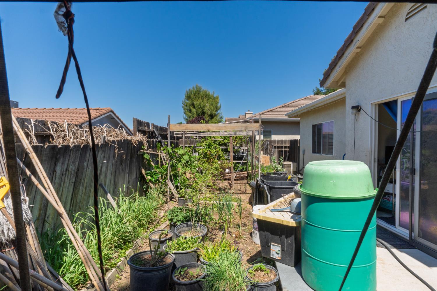 123 Manzanita Avenue Merced, CA 95341 - Photo 27 of 30 a view of a backyard with furniture and a garden