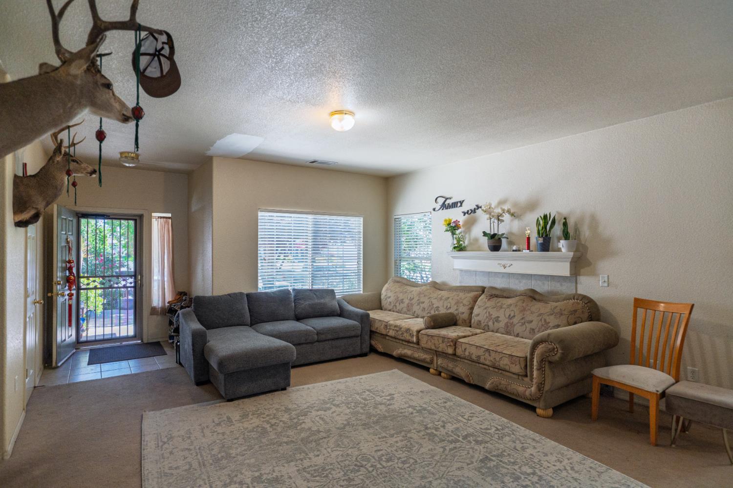 123 Manzanita Avenue Merced, CA 95341 - Photo 3 of 30 a living room with furniture and a window