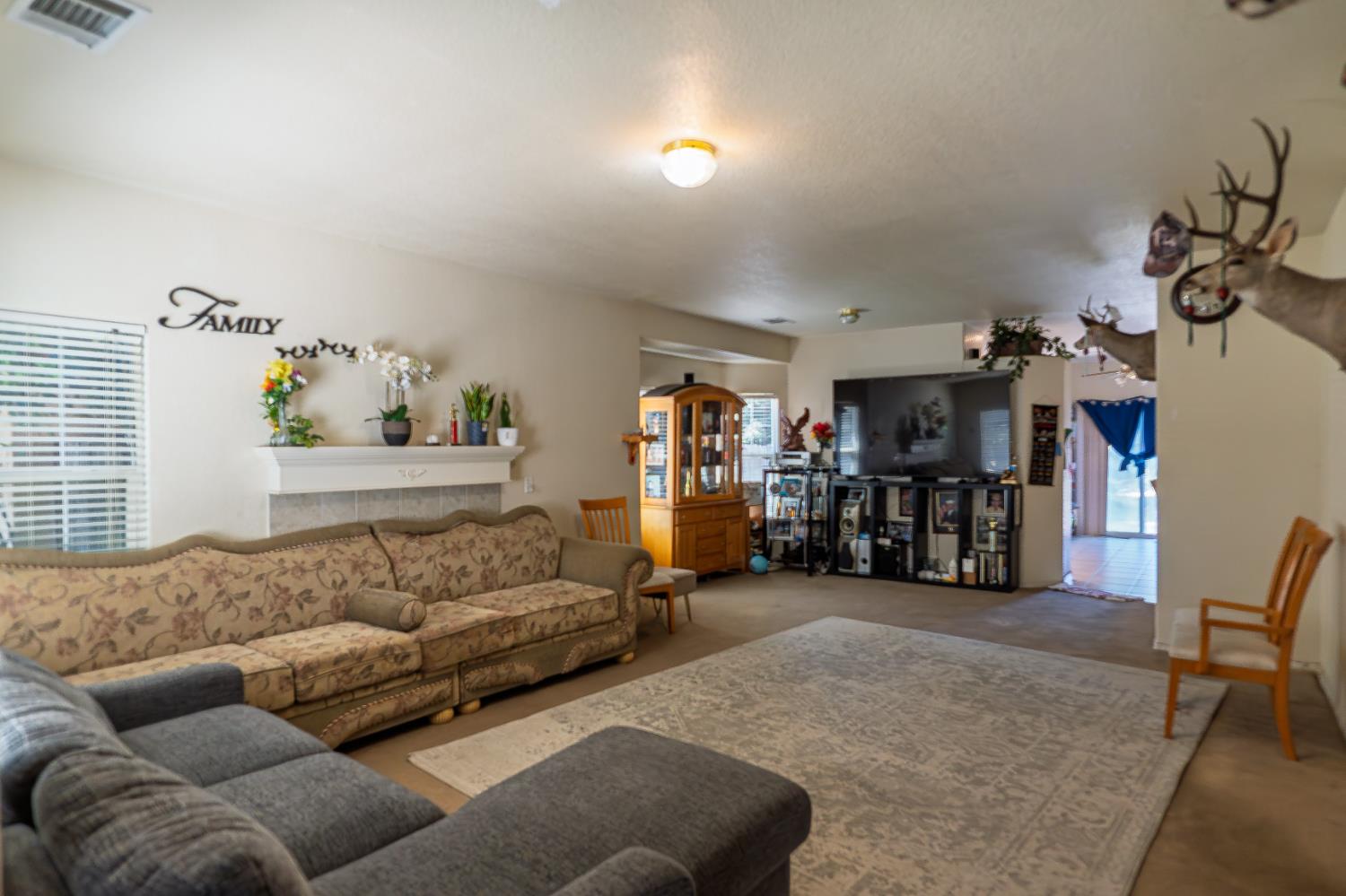 123 Manzanita Avenue Merced, CA 95341 - Photo 4 of 30 a living room with furniture and a flat screen tv
