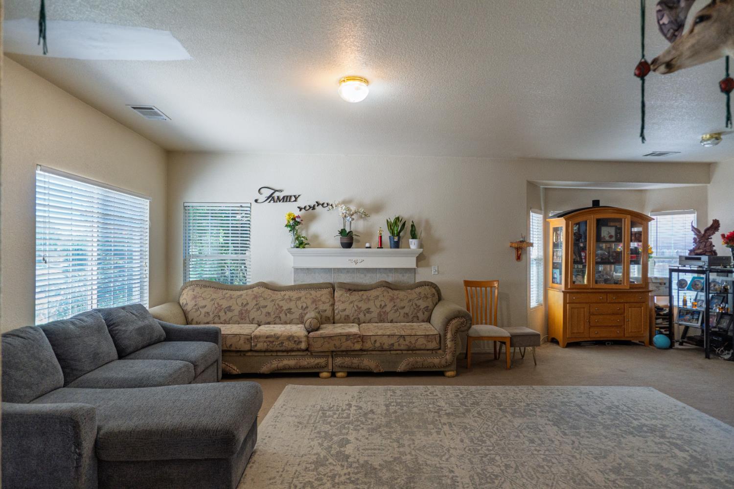 123 Manzanita Avenue Merced, CA 95341 - Photo 5 of 30 a living room with furniture and a window