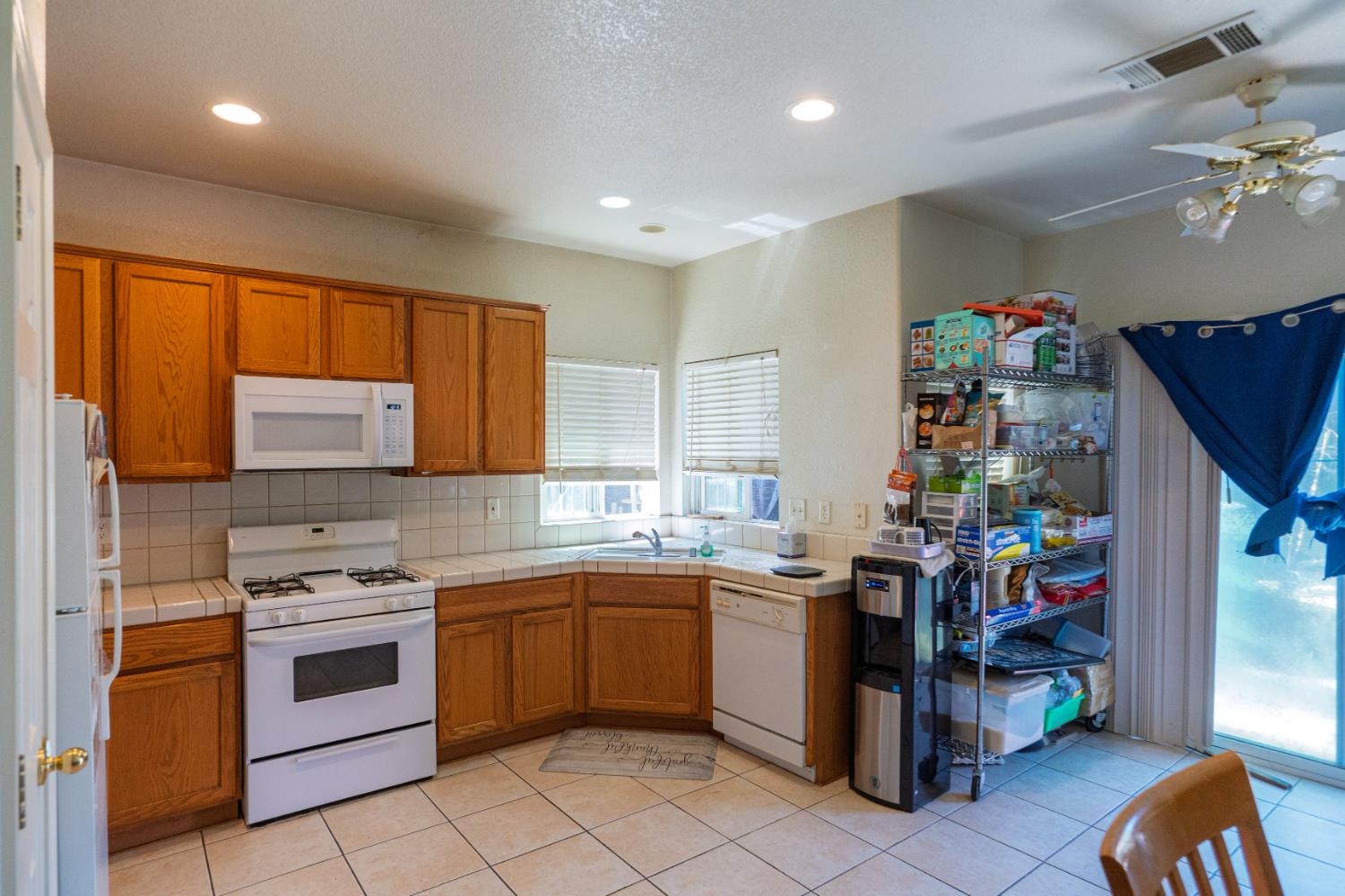 123 Manzanita Avenue Merced, CA 95341 - Photo 6 of 30 a kitchen with a sink stove and cabinets