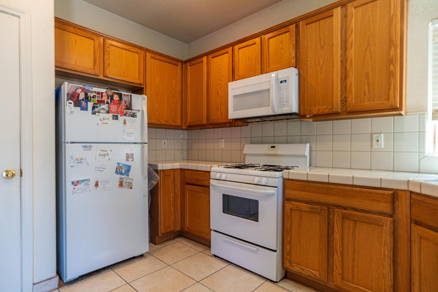 123 Manzanita Avenue Merced, CA 95341 - Photo 8 of 30 a kitchen with stainless steel appliances granite countertop a refrigerator and a stove
