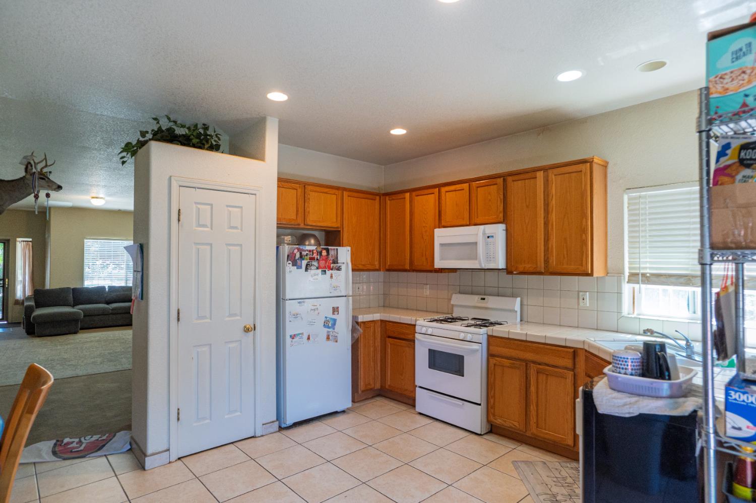 123 Manzanita Avenue Merced, CA 95341 - Photo 9 of 30 a kitchen with a refrigerator and a sink