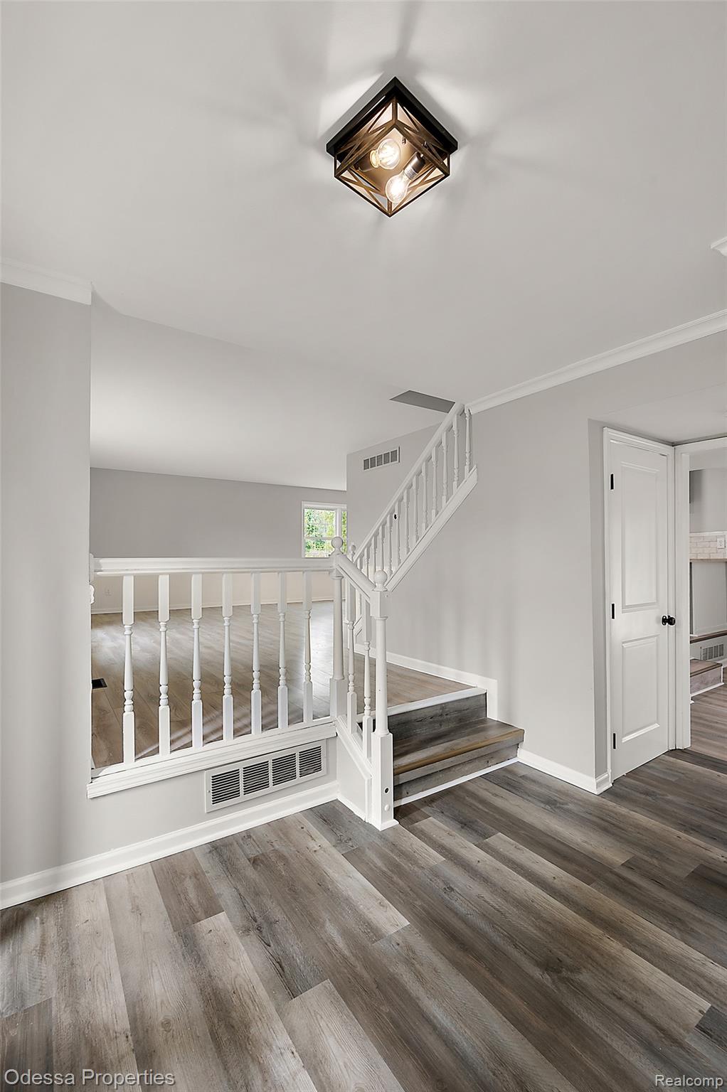 1442 Riley Center Road Memphis, MI 48041 - Photo 16 of 62 Stairway with crown molding and wood finished floors