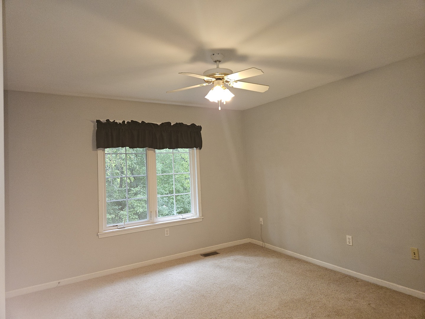 688 Fox Hollow Court DeKalb, IL 60115 - Photo 14 of 31 an empty room with a window and a fan