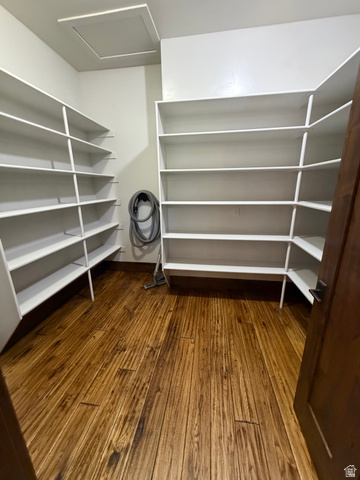4536 North 475 East Provo, UT 84604 - Photo 46 of 65 Spacious pantry featuring extensive white shelving, rich wood-finish flooring, and a ceiling access panel