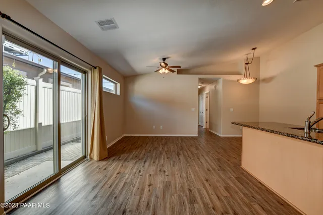 a view of a room with wooden floor and a window