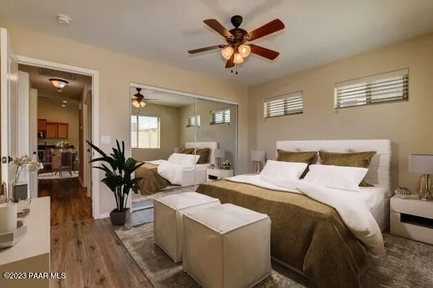 a bedroom with a large bed and a chandelier