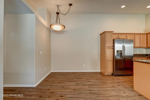 a view of a kitchen with a sink and refrigerator