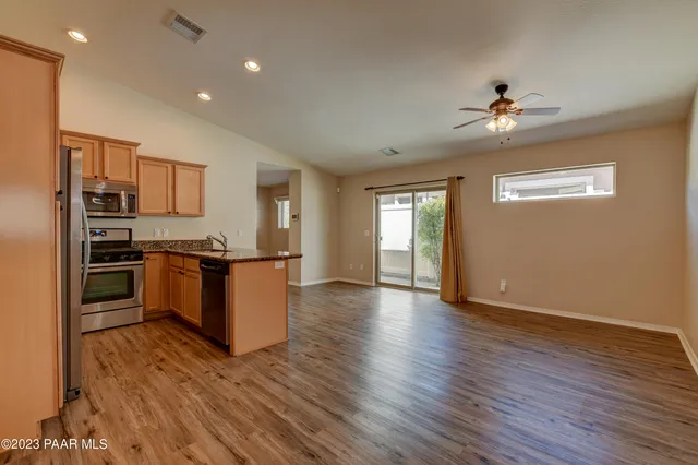 a kitchen with a refrigerator and a stove top oven