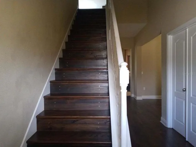 a view of entryway and gallery with wooden floor