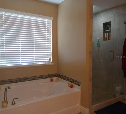 a bath tub sitting in a bathroom next to a window