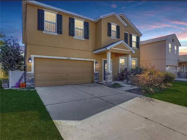 a front view of a house with a yard and garage