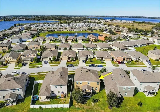 an aerial view of multiple house with yard