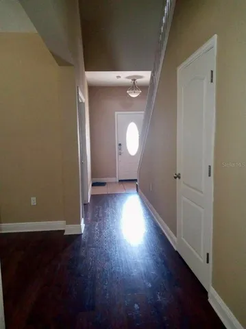 a view of a room with wooden floor and window