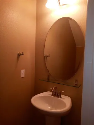 a bathroom with a sink and mirror