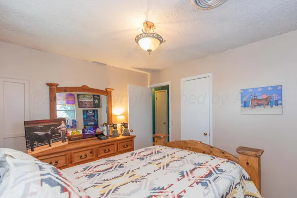 a bedroom with bed and a book shelf