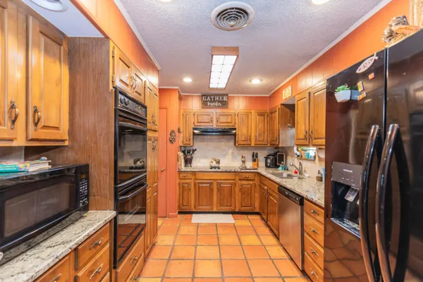 a kitchen with stainless steel appliances granite countertop a sink and cabinets