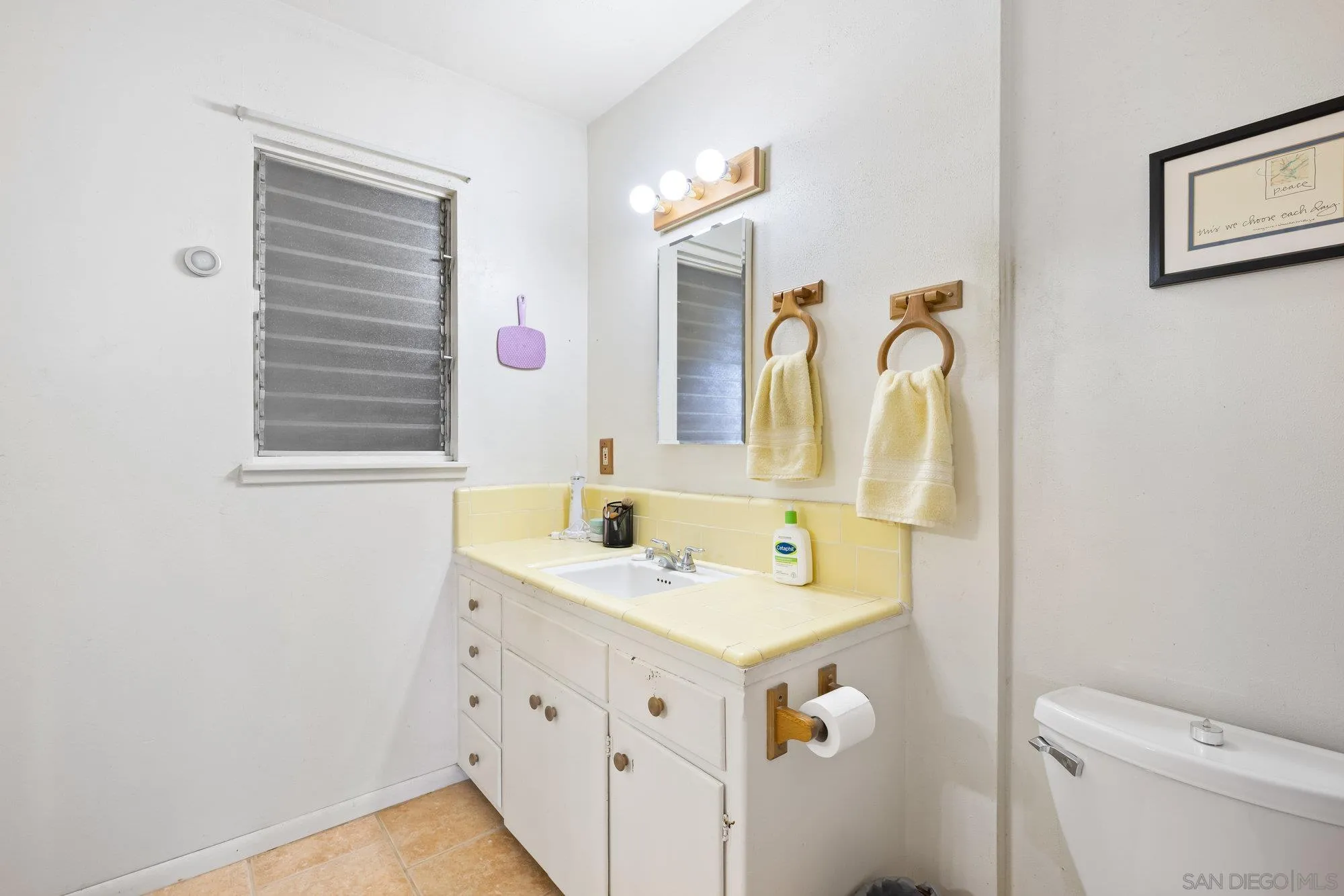 10407 Hawley Road El Cajon, CA 92021 - Photo 13 of 40 a bathroom with a sink a vanity and a mirror