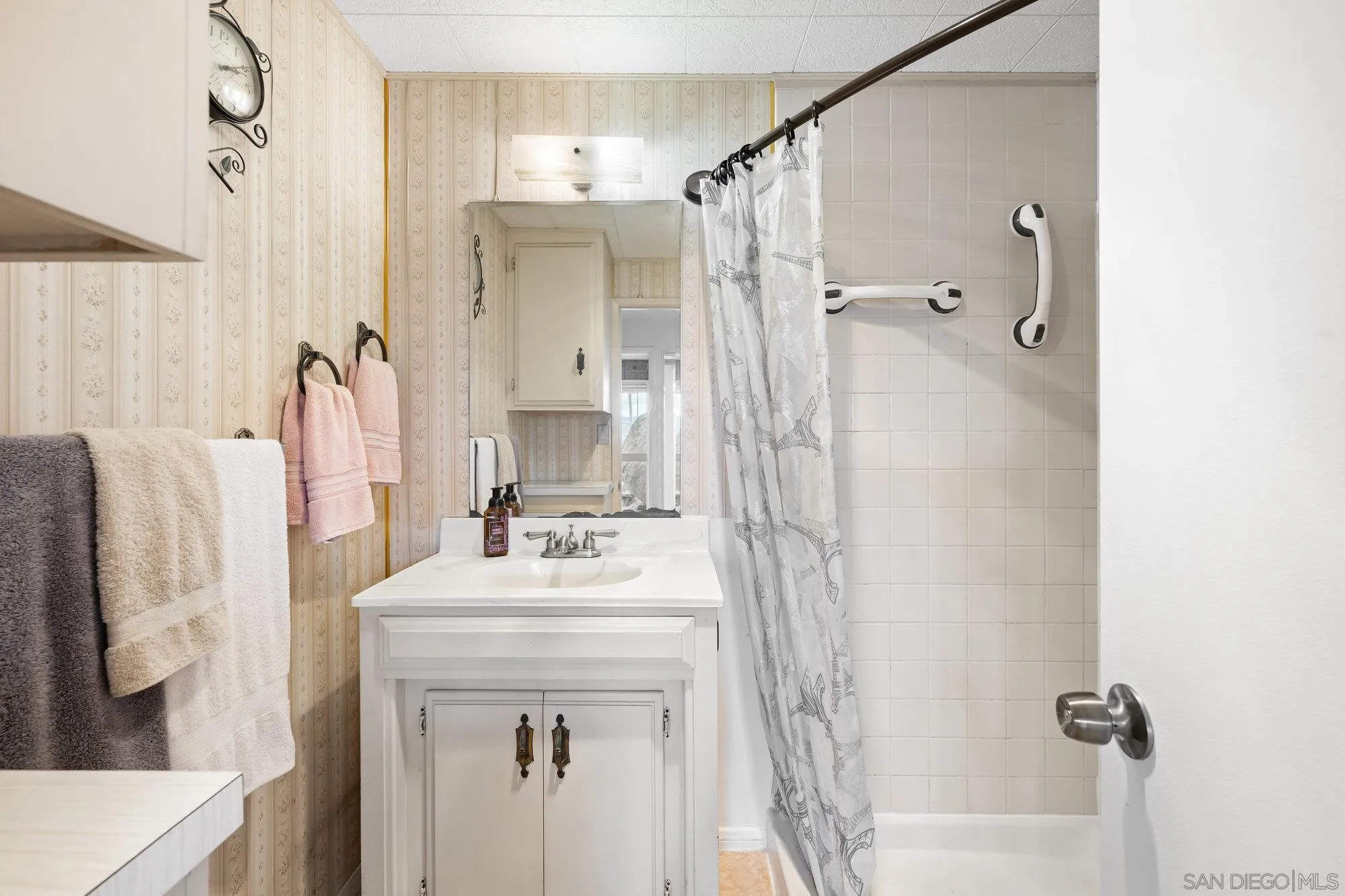 10407 Hawley Road El Cajon, CA 92021 - Photo 16 of 40 a bathroom with a sink vanity mirror and shower