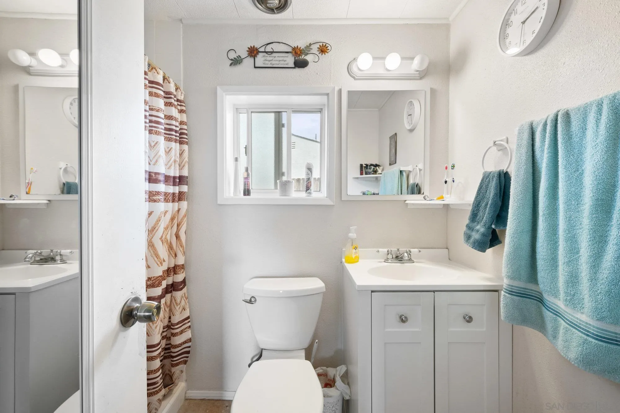 10407 Hawley Road El Cajon, CA 92021 - Photo 17 of 40 a bathroom with a sink a toilet and a mirror