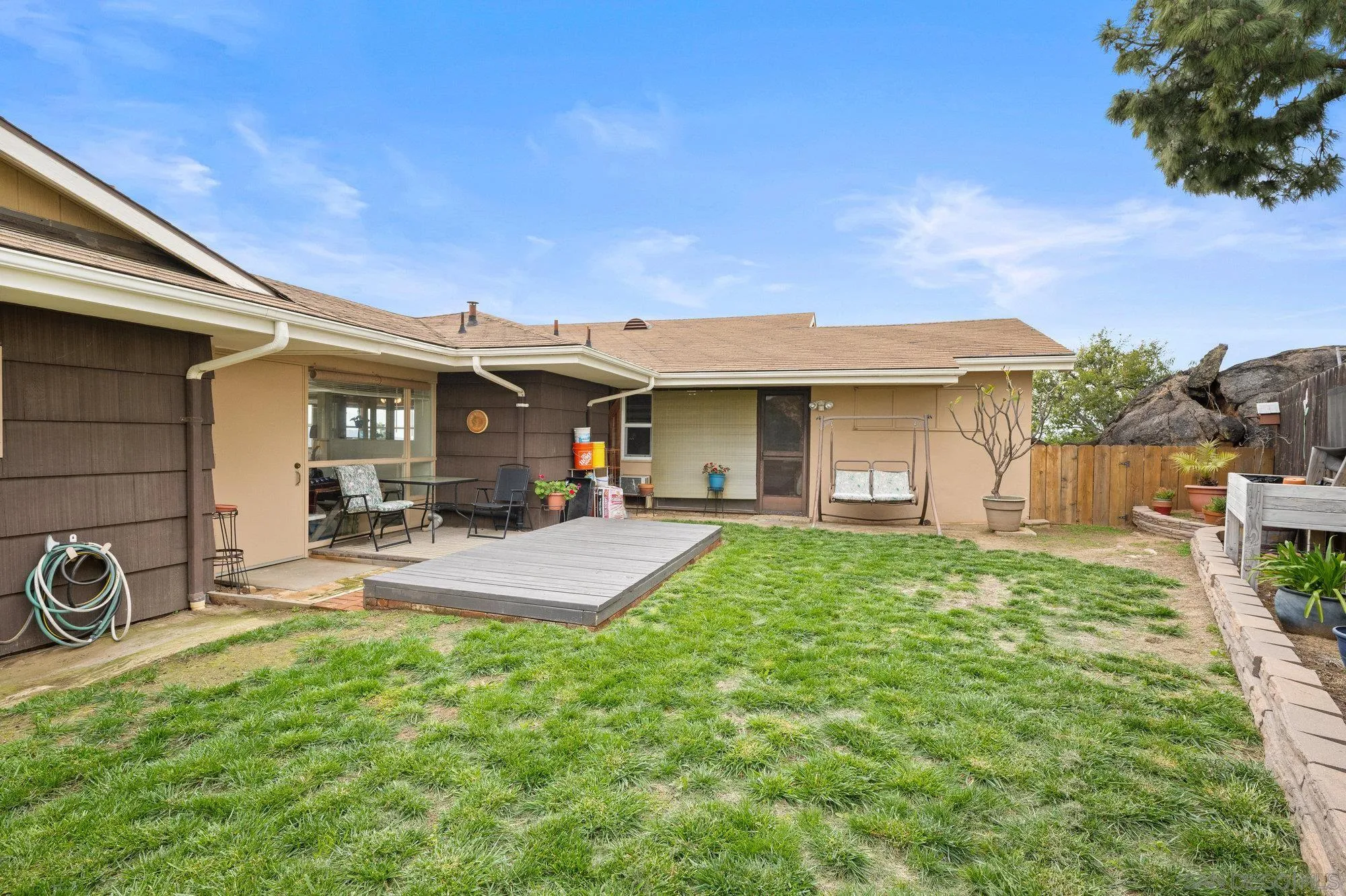 10407 Hawley Road El Cajon, CA 92021 - Photo 24 of 40 a view of a house with backyard porch and garden