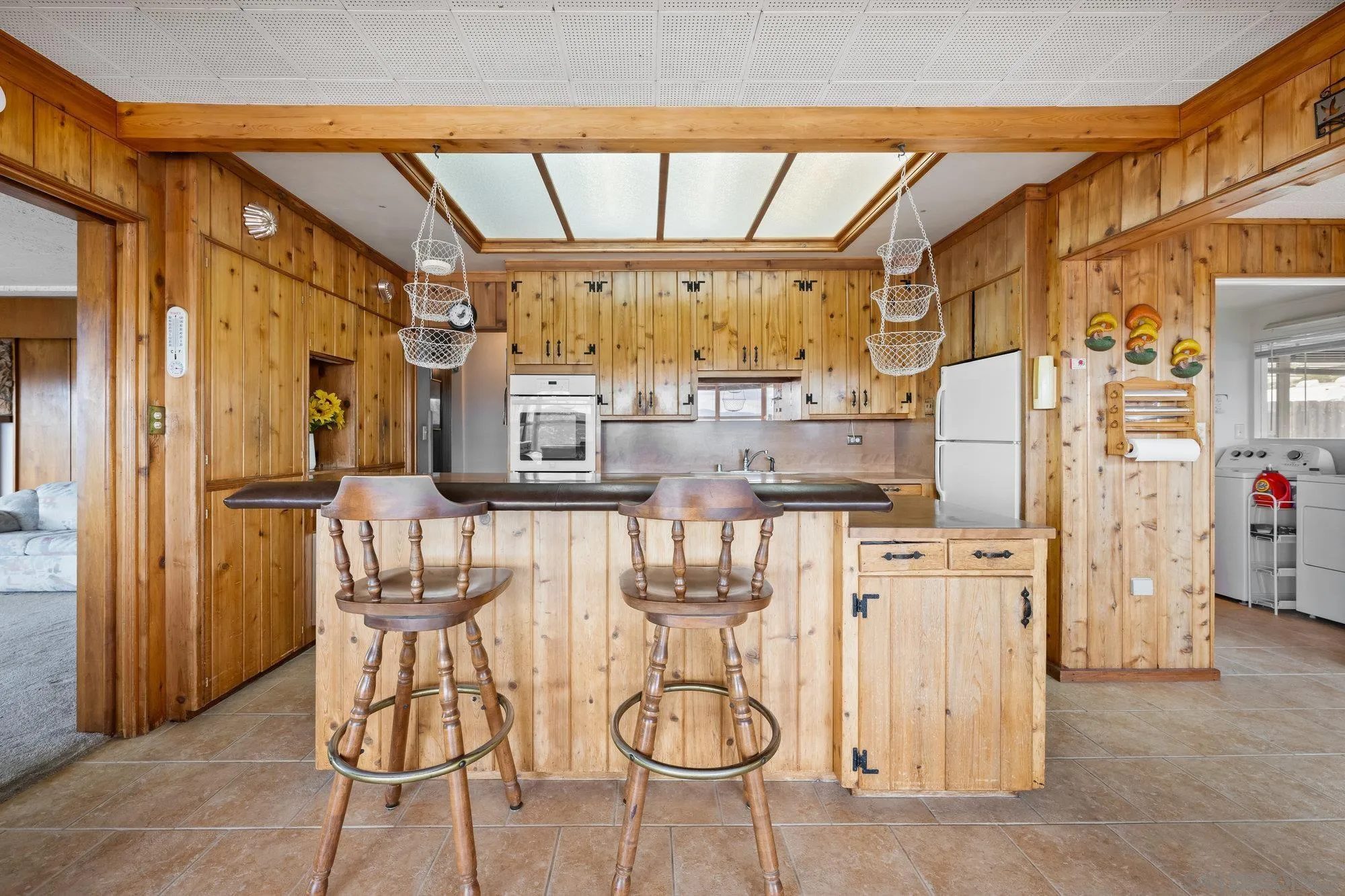 10407 Hawley Road El Cajon, CA 92021 - Photo 9 of 40 a kitchen with stainless steel appliances kitchen island granite countertop a refrigerator and microwave