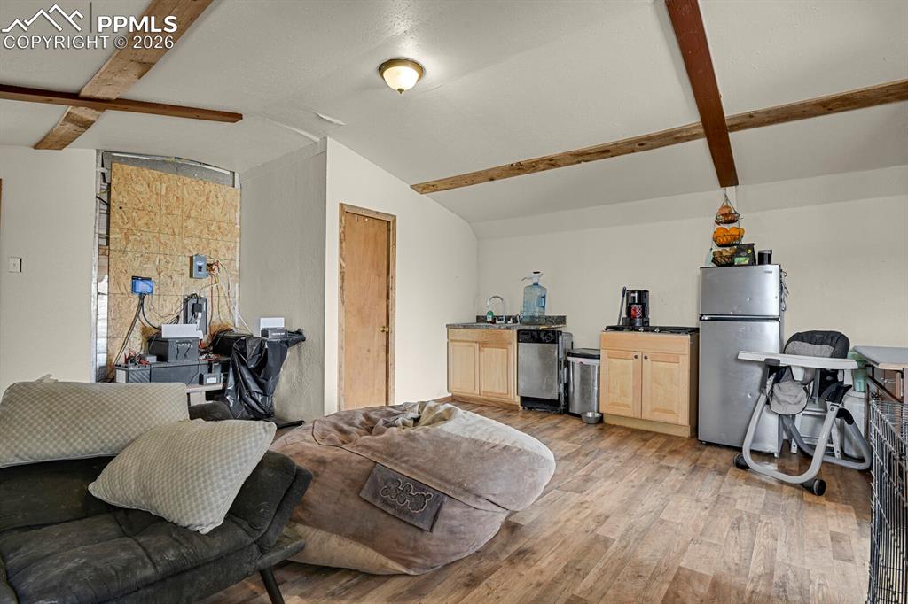 30203 Sanborn Road Yoder, CO 80864 - Photo 6 of 38 a bed room with furniture and a wooden floor