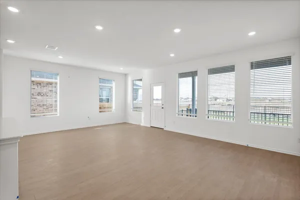 a view of a kitchen with refrigerator and white cabinets