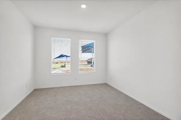 a view of an empty room with a kitchen
