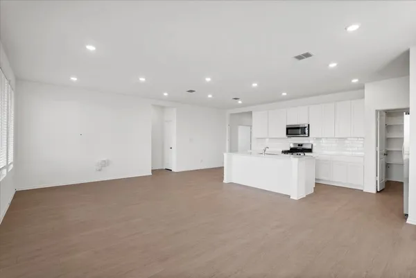 a view of kitchen with white cabinets and white appliances