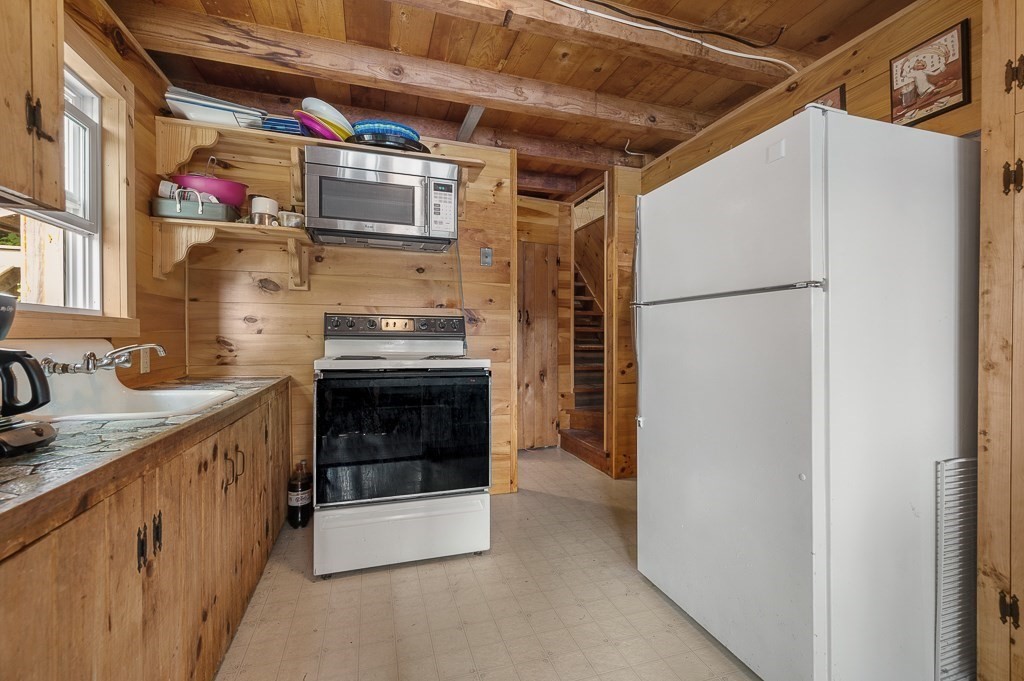 42 Goodrich Road Sturbridge, MA 01566 - Photo 12 of 36 a kitchen with stainless steel appliances granite countertop a refrigerator and a stove