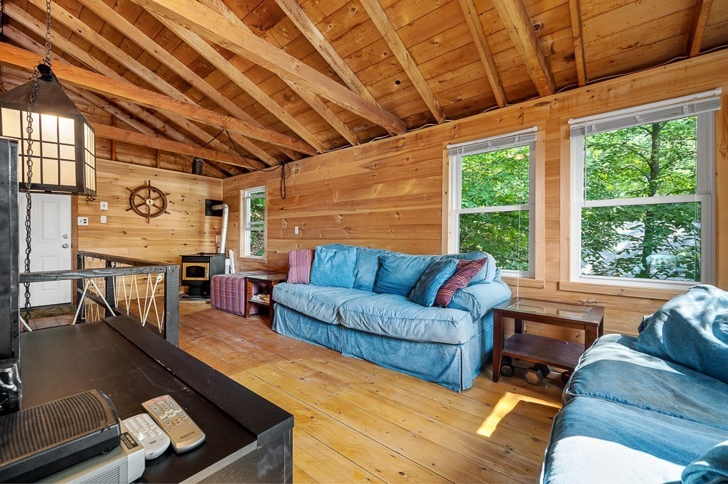 42 Goodrich Road Sturbridge, MA 01566 - Photo 6 of 36 a living room with furniture a large window with kitchen view
