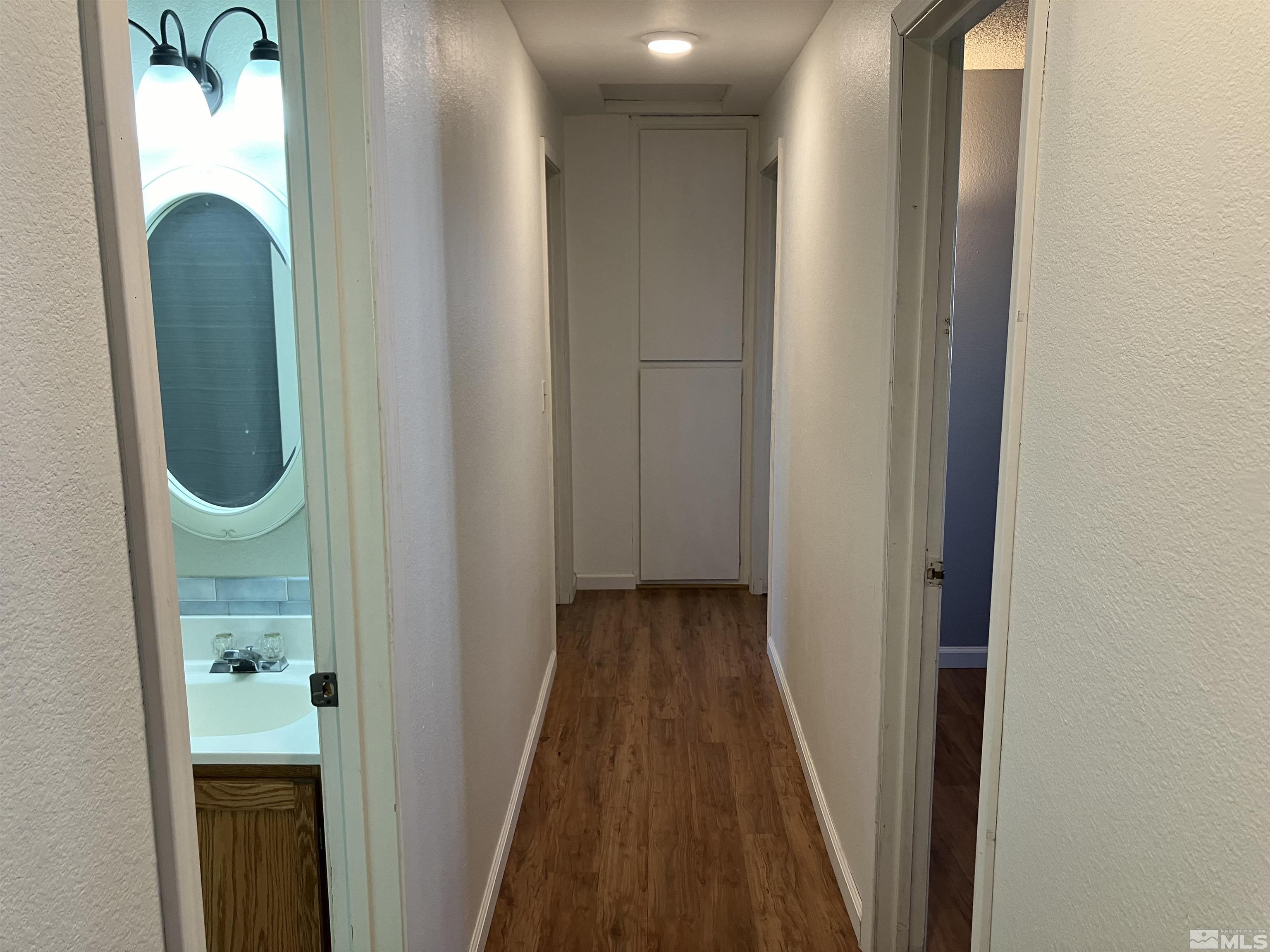 13041 Exinite Drive Reno, NV 89506 - Photo 17 of 23 an entryway with wooden floor mirror and a sink