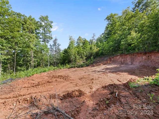a wooden bench with view of trees