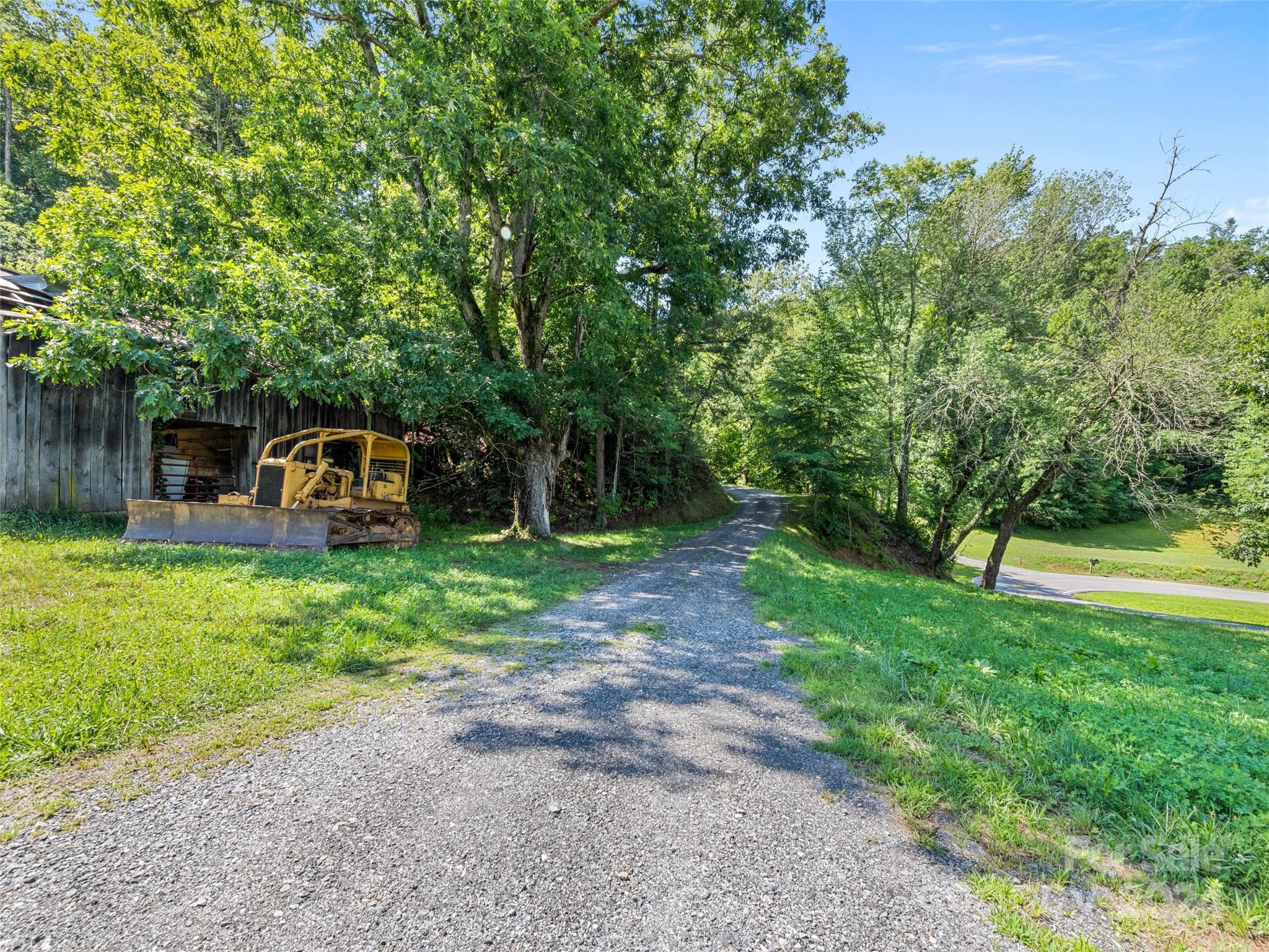0 Ashe Loop Road Sylva, NC 28779 - Photo 2 of 23 a backyard of a house with barbeque oven table and chairs