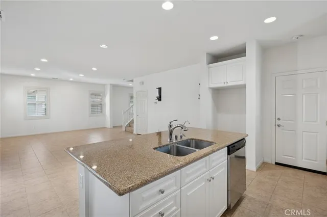 a kitchen with sink and mirror