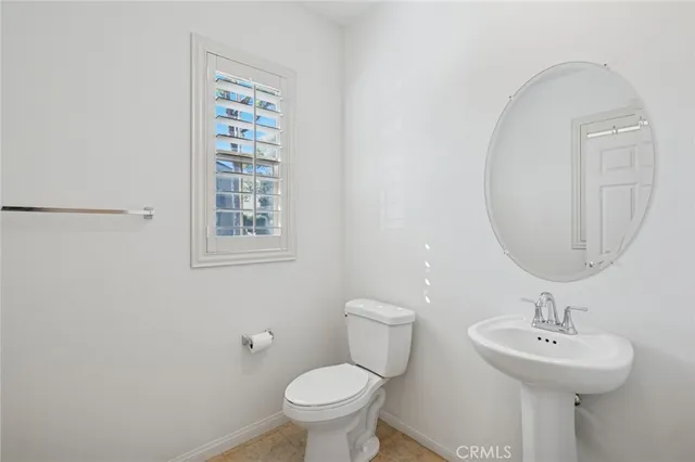 a bathroom with a sink toilet and a mirror