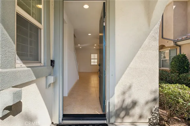 a view of a living room with a white door and wooden floor