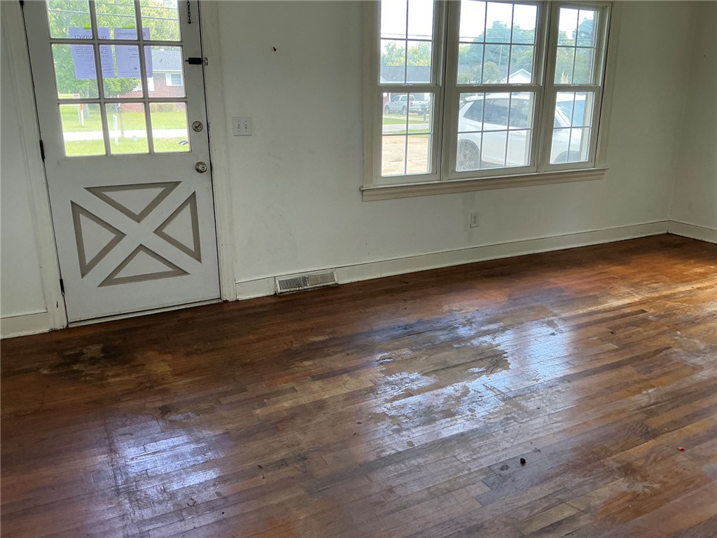 609 West Geer Street Honea Path, SC 29654 - Photo 8 of 18 Original hardwood floors and classic multi-pane windows define this versatile entry space.