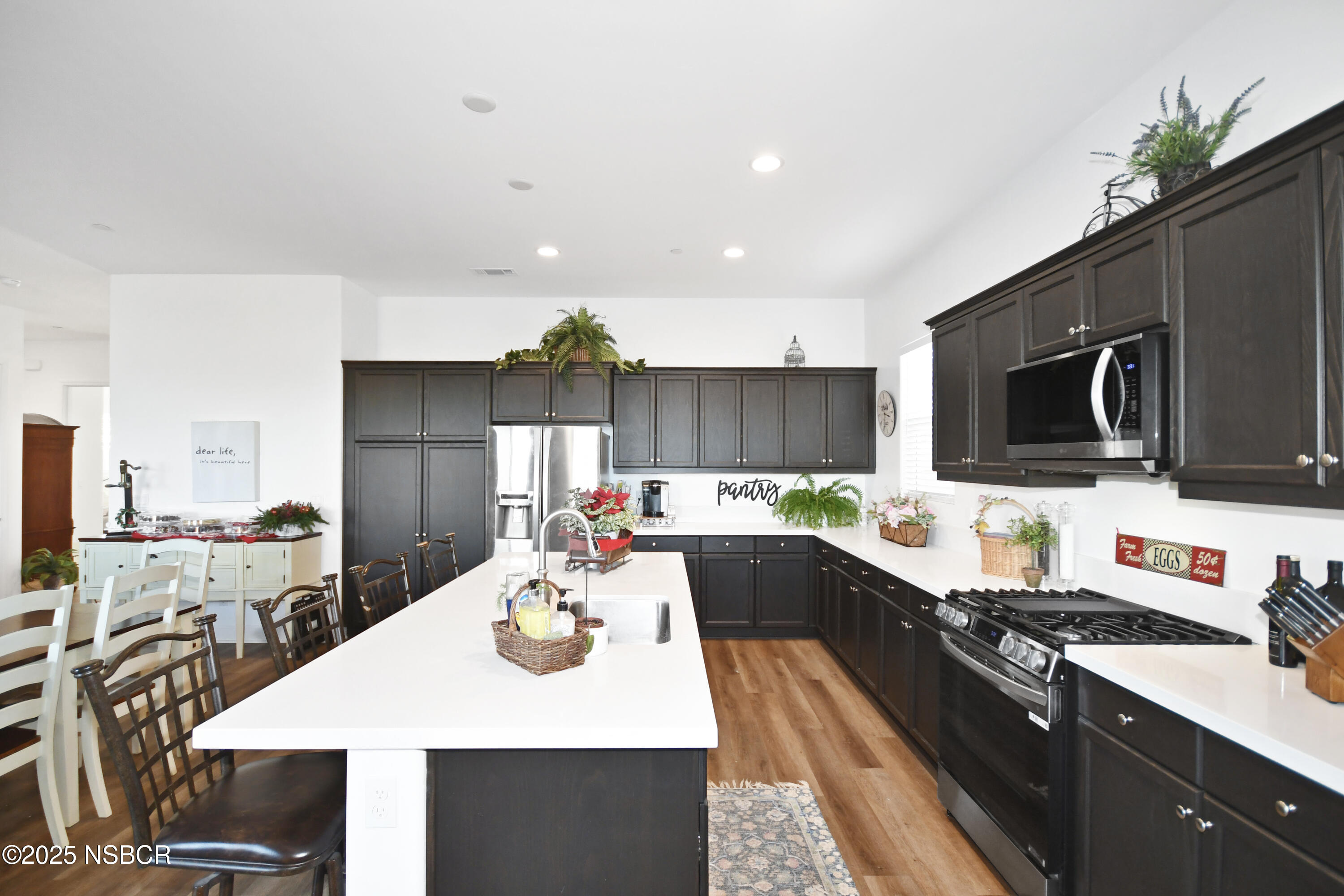 813 Skyview Lane Santa Maria, CA 93455 - Photo 18 of 49 a kitchen with a sink a stove and chairs