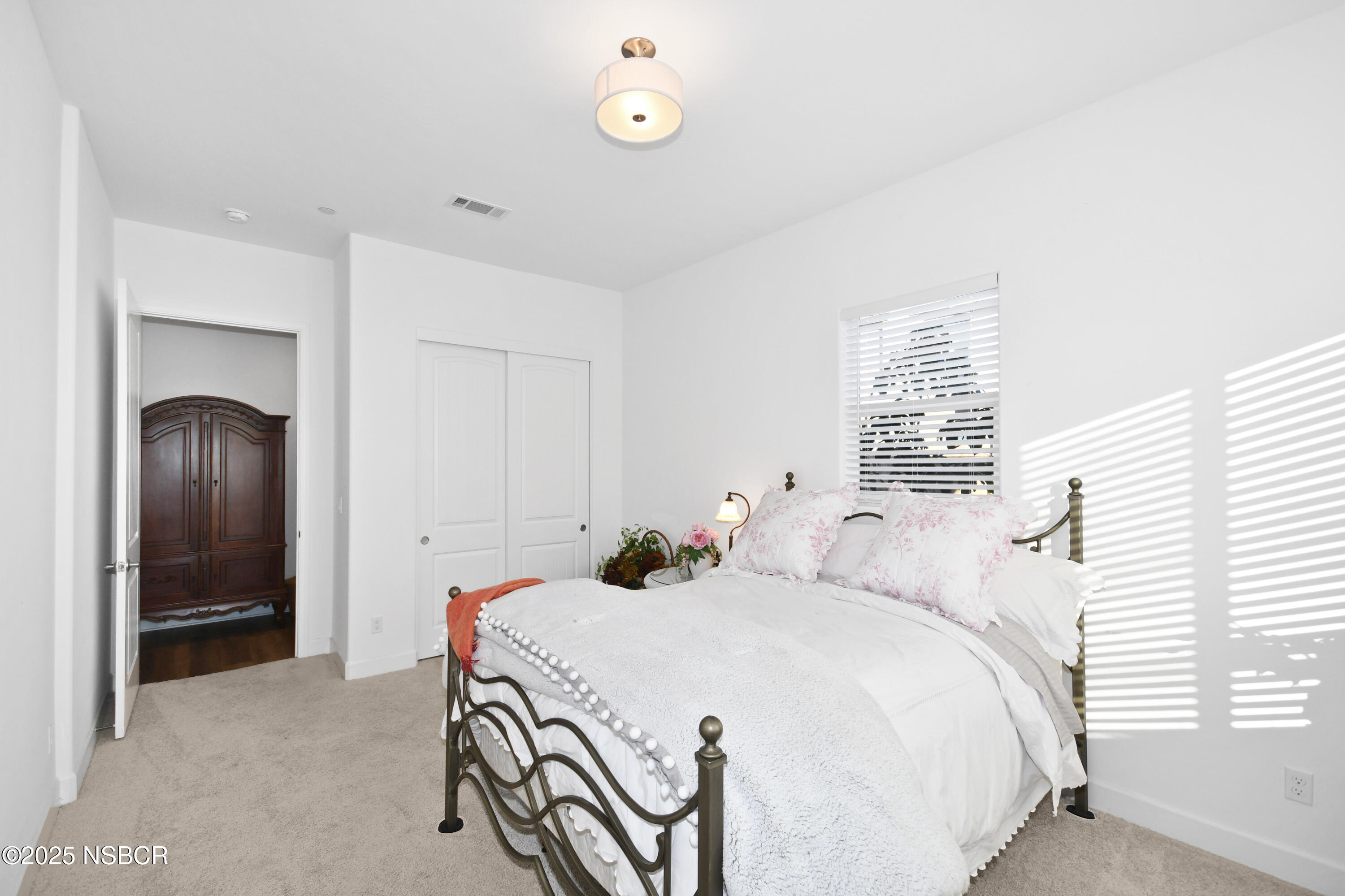 813 Skyview Lane Santa Maria, CA 93455 - Photo 9 of 49 a bedroom with a bed and a chandelier