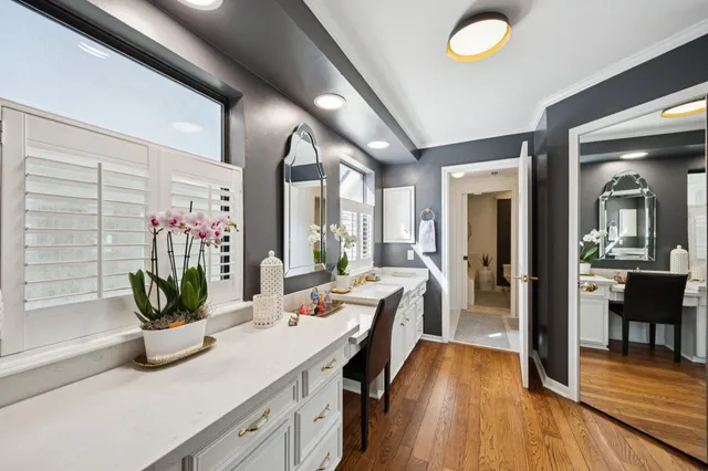 a view of a kitchen area with furniture and wooden floor