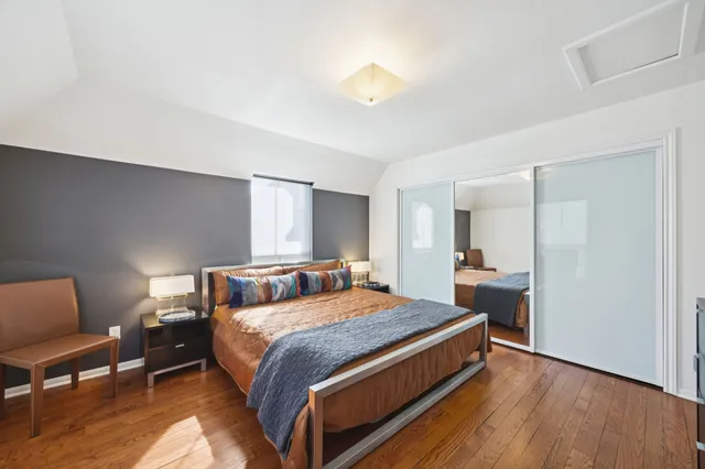 a bed room with a bed and a chair