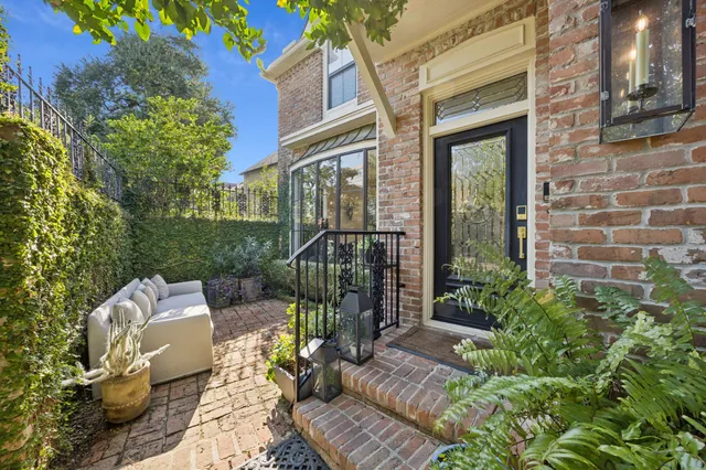 a view of a patio with couches chairs and potted plants
