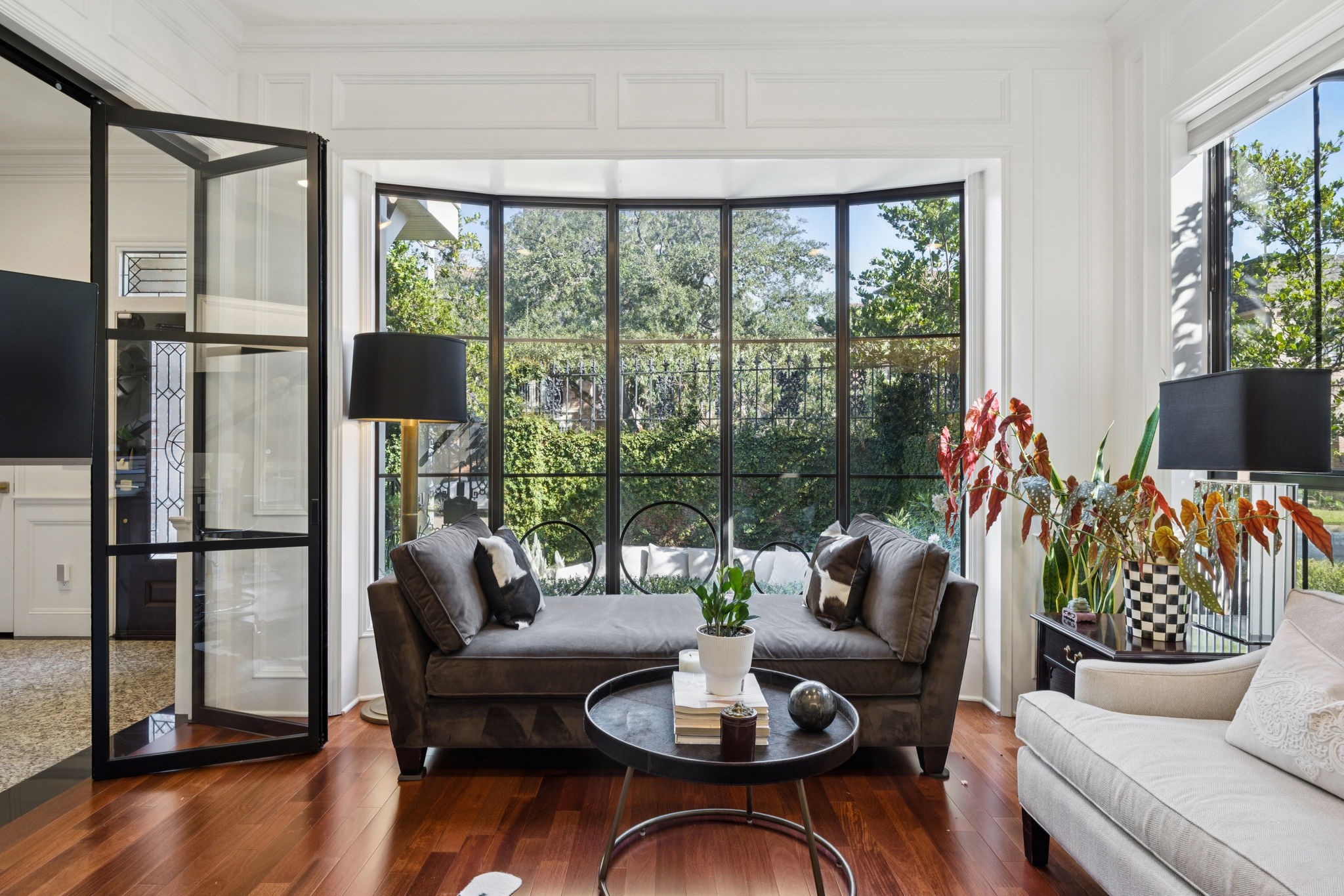 4964 Post Oak Timber Drive Houston, TX 77056 - Photo 9 of 48 Bathed in soft northeastern sunlight, this luxurious study features custom glass doors, new windows, refined built-ins, and a private full ensuite bath—creating an elegant and versatile retreat for work or relaxation.