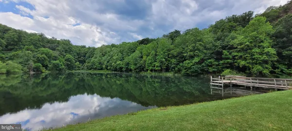a view of a lake with a house in the background