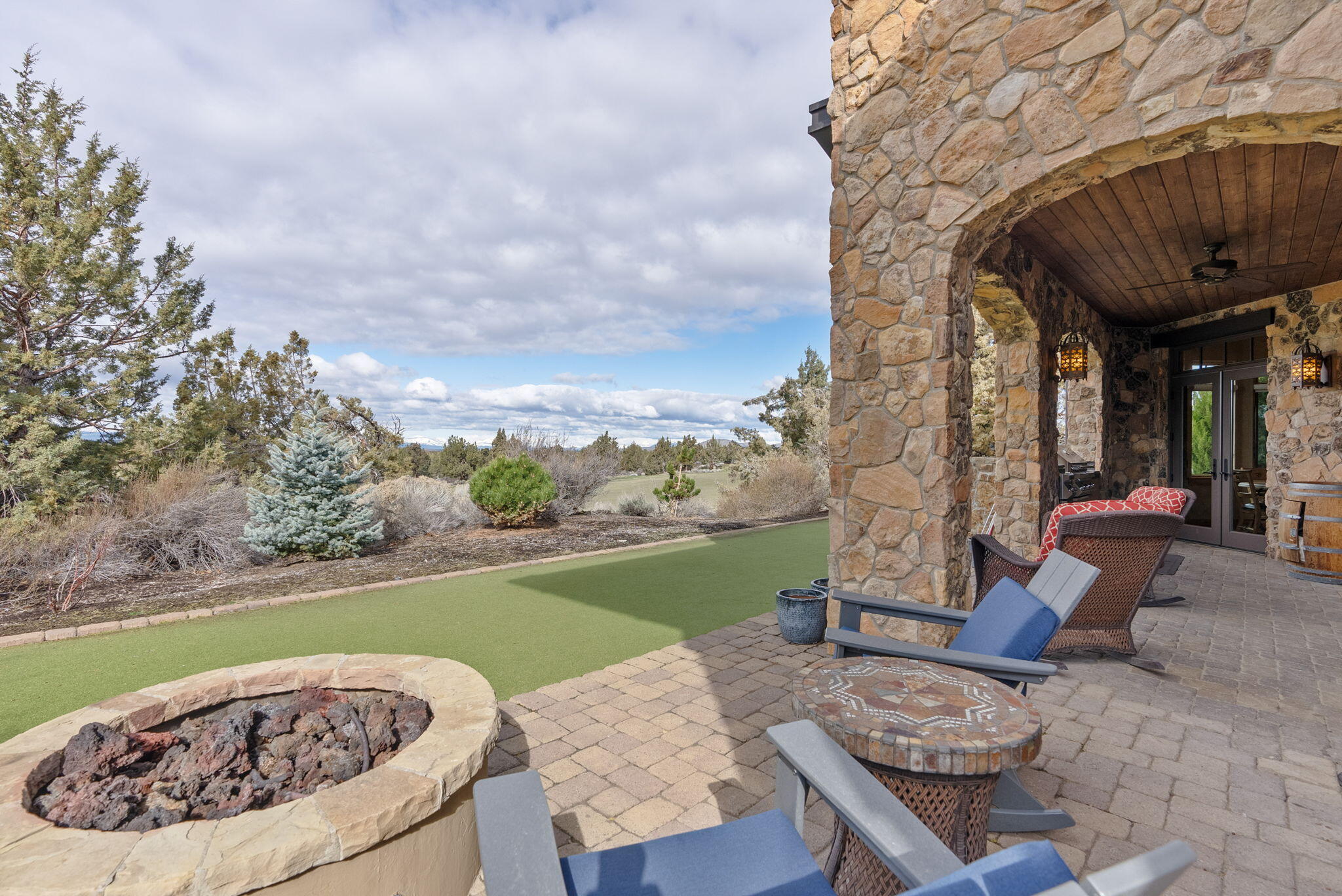 22887 Ghost Tree Lane Bend, OR 97701 - Photo 31 of 97 Enjoy the mountian views from the rear paver patio complete with gas firepit, outdoor kitchen and putting green/bocceball court